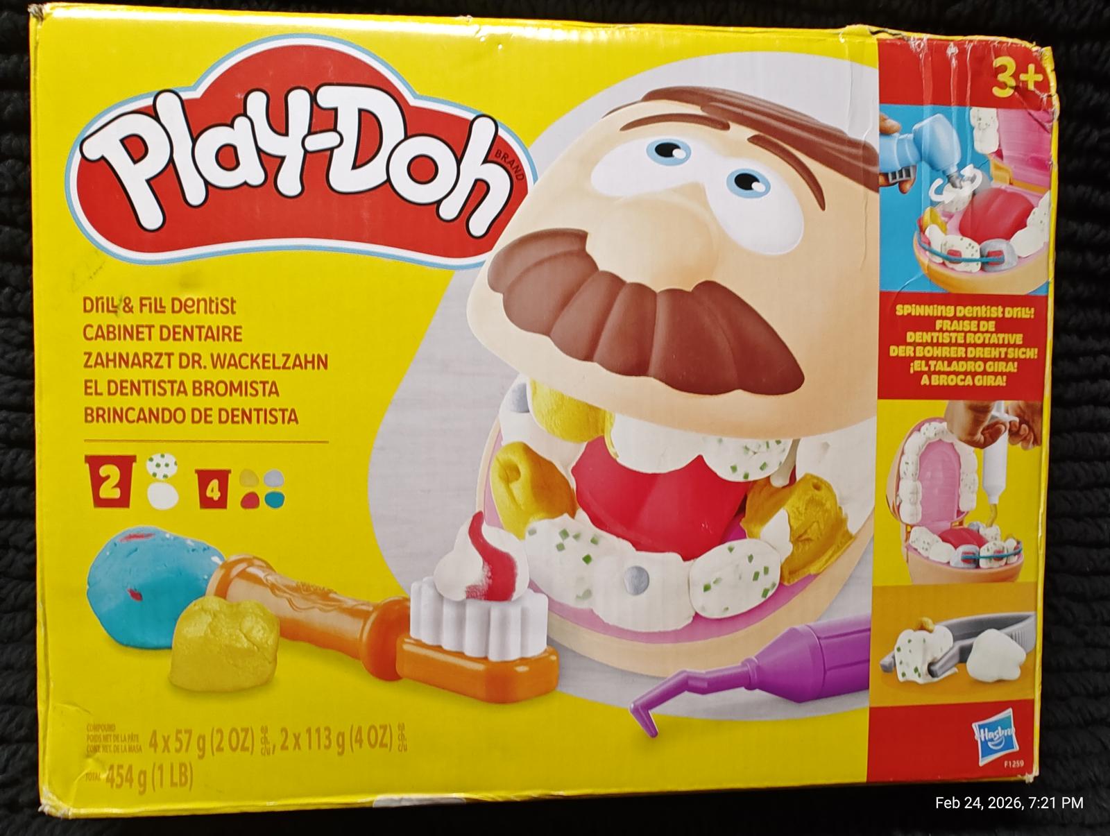 Play-Doh Dentist Set with colorful tools and a smiling character for creative play.