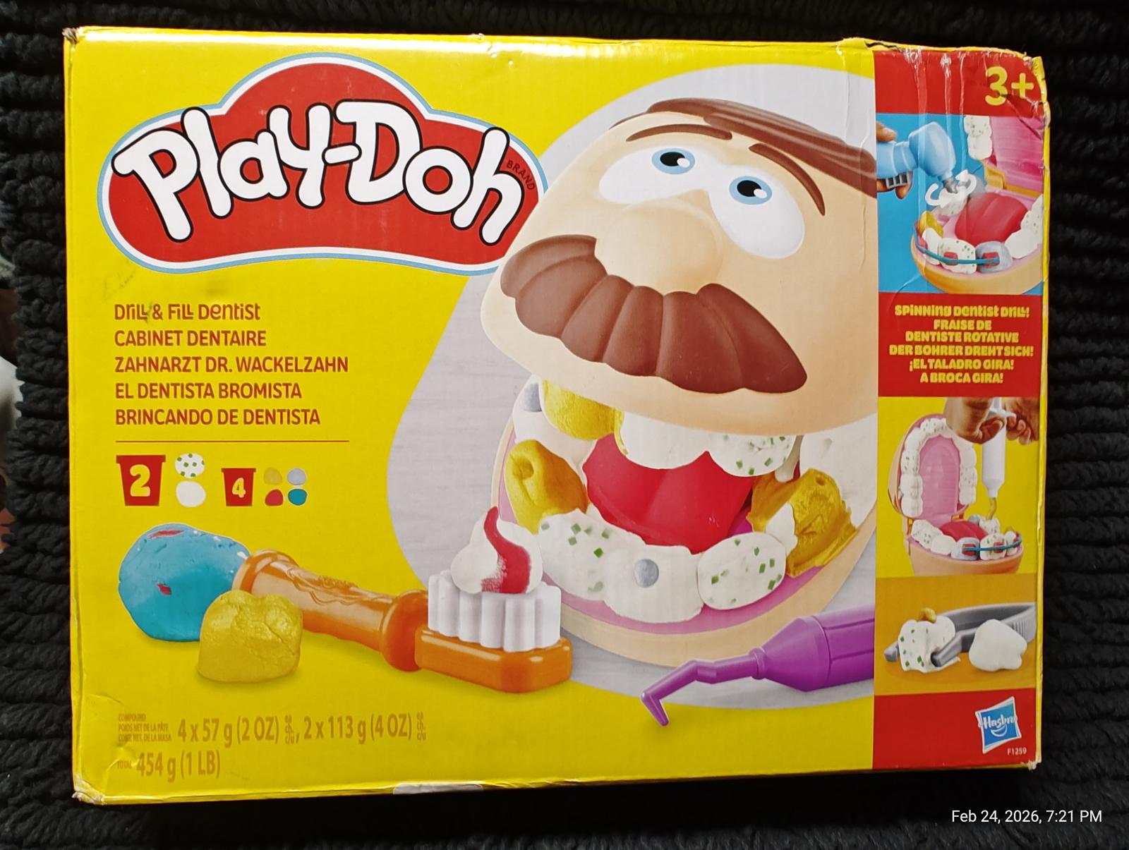 Play-Doh dentist set with colorful tools and character head for creative play.