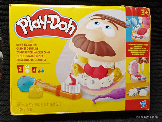 Play-Doh dentist set with colorful tools and character head for creative play.