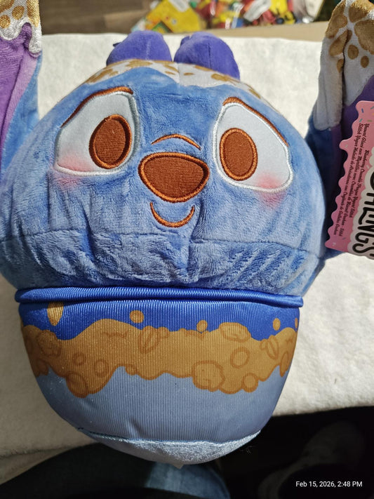 Plush Cookie Monster toy featuring blue and brown colors with a happy expression.