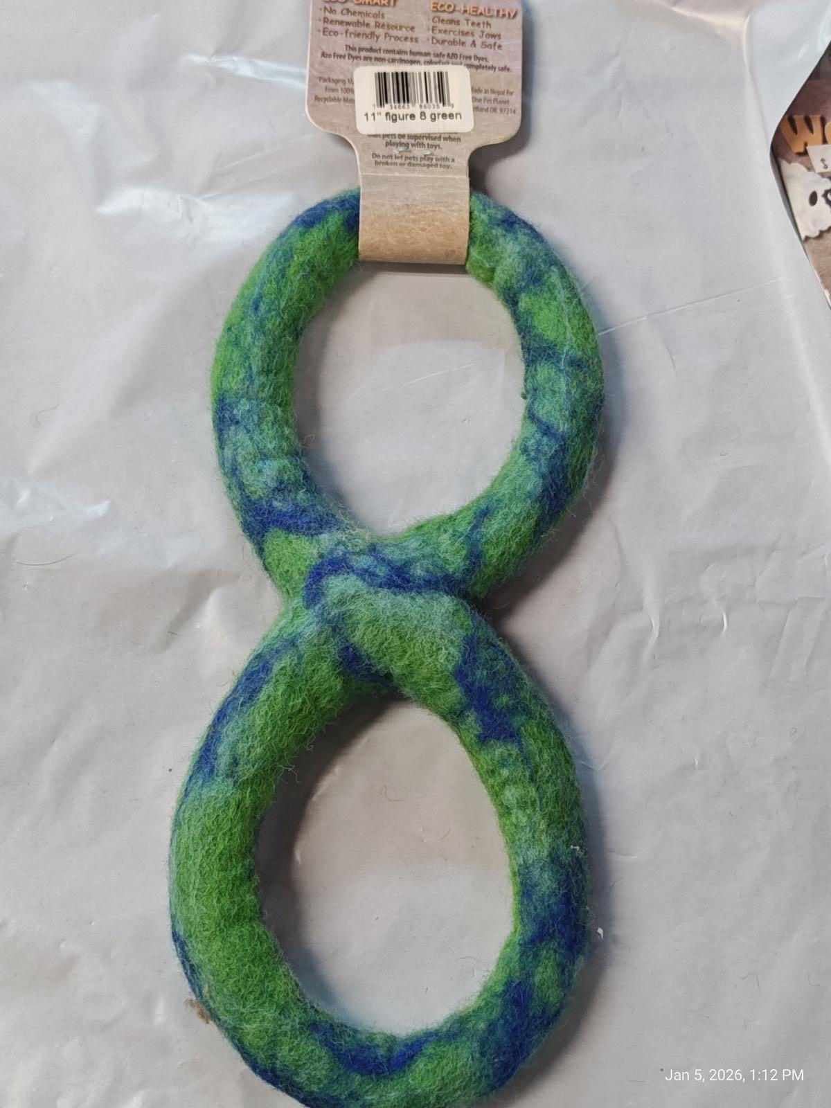 Green and blue plush dog toy shaped like an infinity loop.