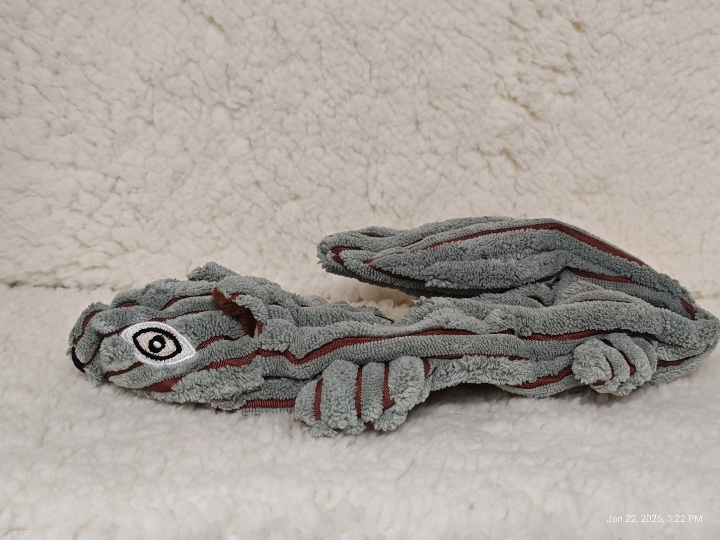 Plush Dragon Toy featuring a soft gray texture and playful design.