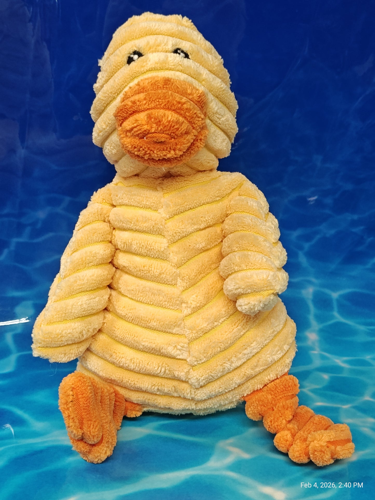 Plush Duck Toy featuring soft, textured yellow and orange fabric, perfect for cuddling.