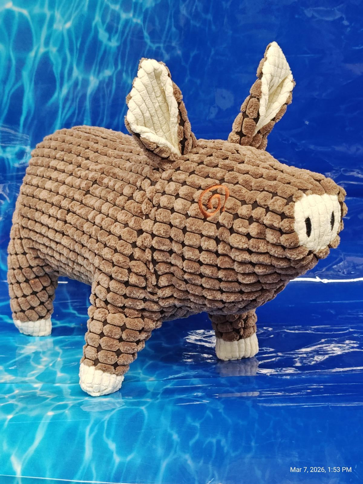 Plush Pig Toy with textured brown fabric and cute ears, perfect for cuddling.