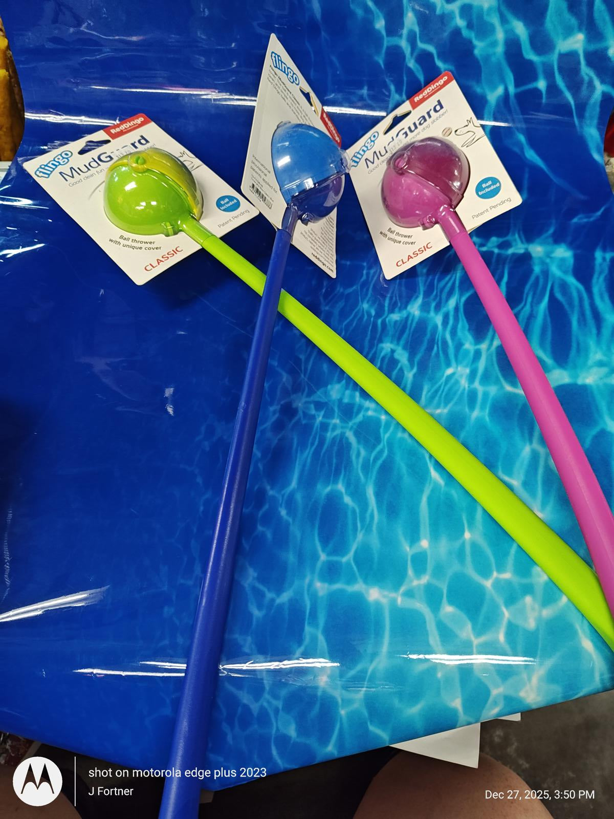 PoolGuard pool skimmer with colorful handles in blue, green, and pink.
