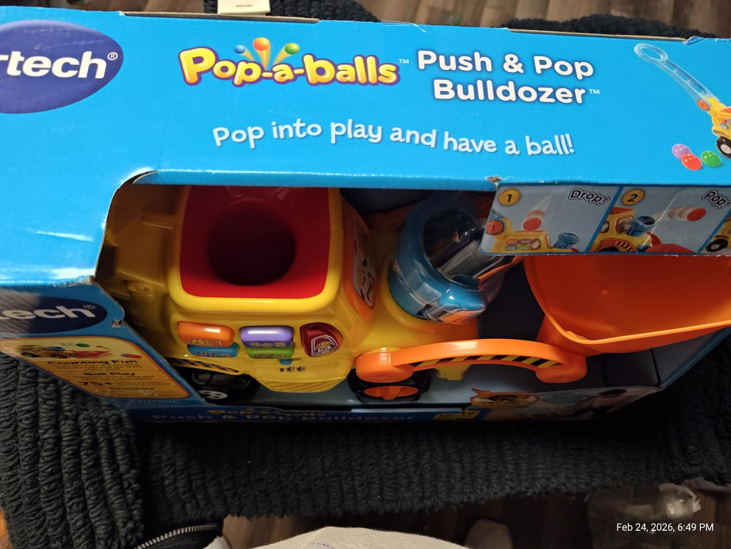 Pop-a-balls Push & Pop Bulldozer toy in colorful packaging with ball popping feature.