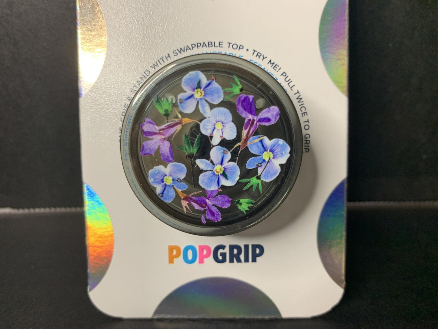 PopGrip featuring a floral design with purple and blue flowers on a black background.