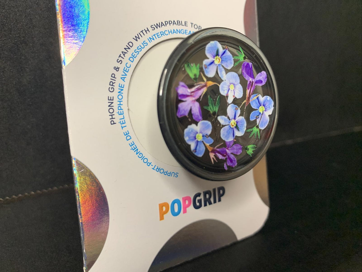 PopGrip with vibrant purple flower design on a black background.