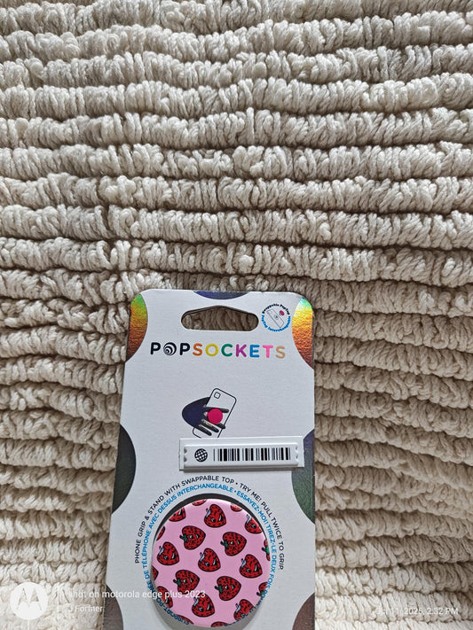 PopSockets grip with pink hearts design on a textured background.