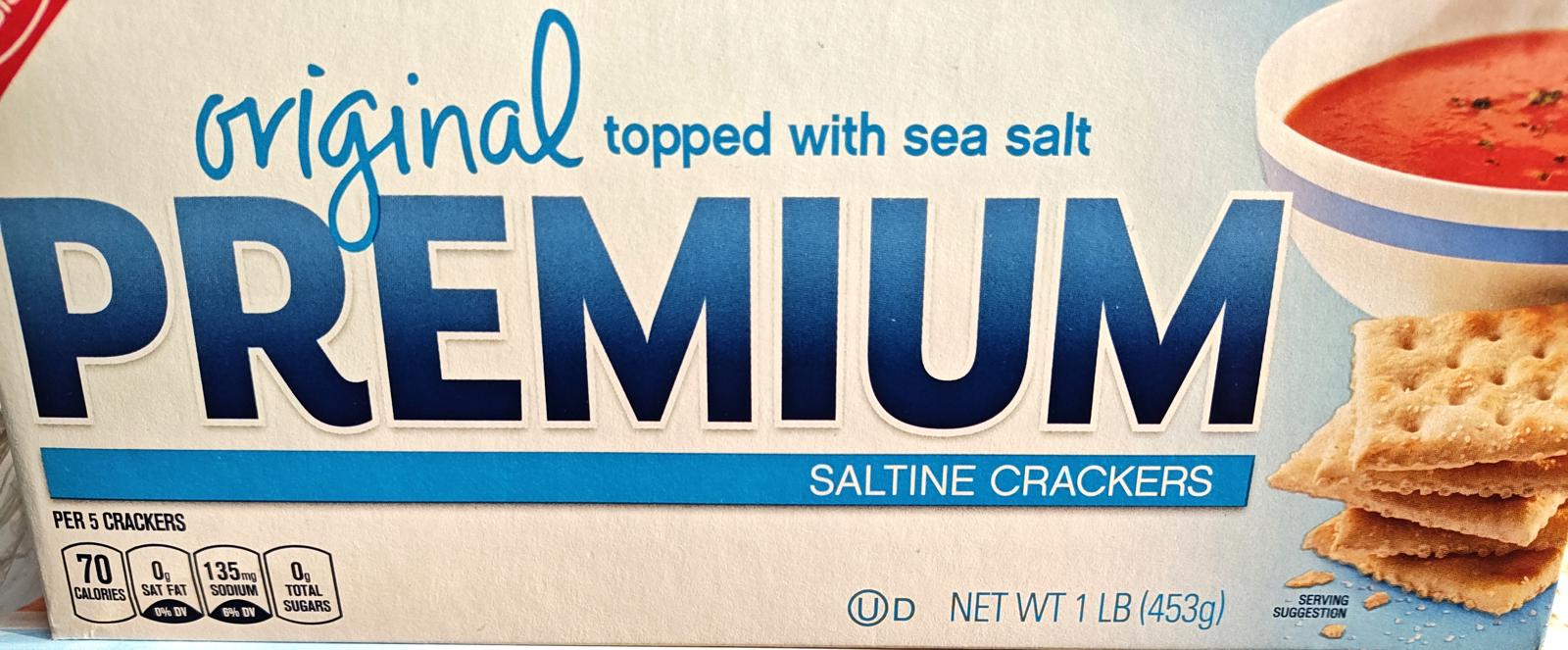 Premium saltine crackers topped with sea salt, perfect for snacking or pairing with soup.