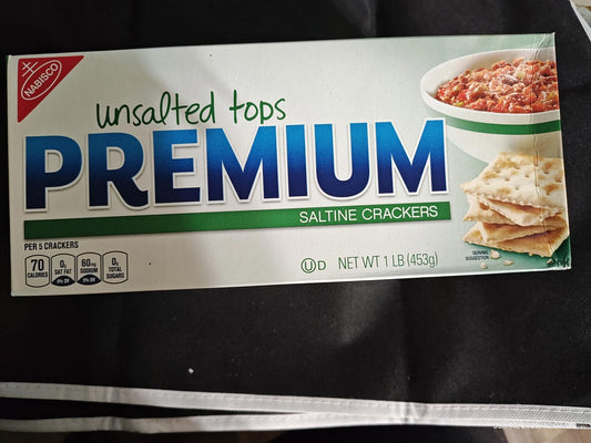 Premium saltine crackers in unsalted tops packaging with a bowl of dip.