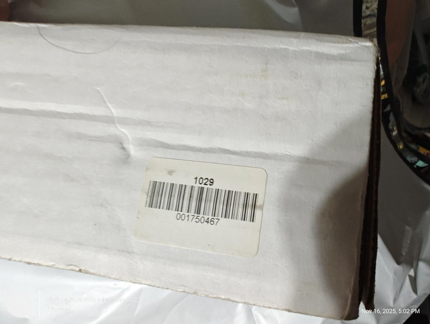 Product box with barcode label and shipping details.