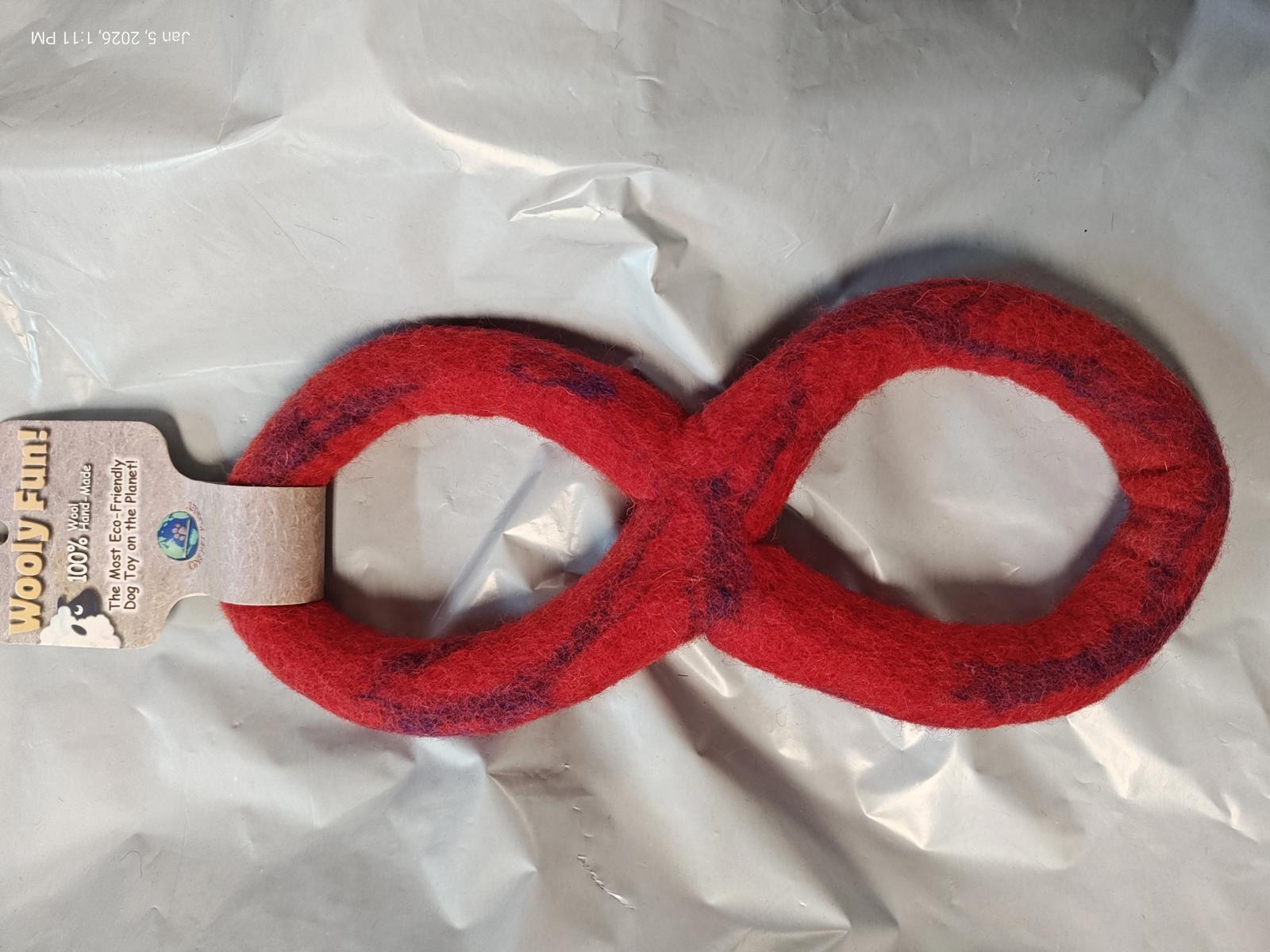 Red infinity dog toy made of durable fabric for playful pets.