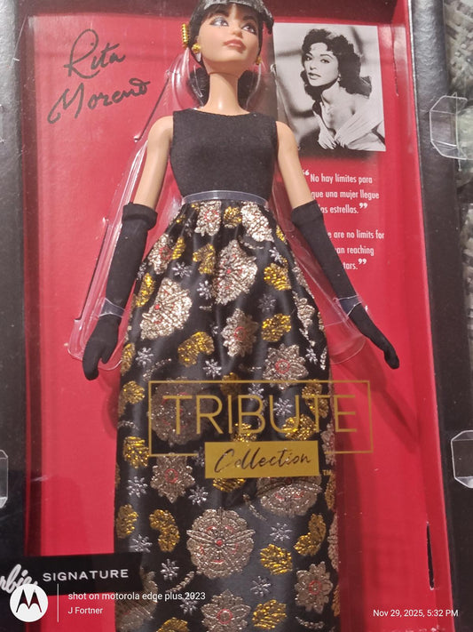 Rita Moreno doll from the Tribute Collection wearing a black gown with gold floral patterns.
