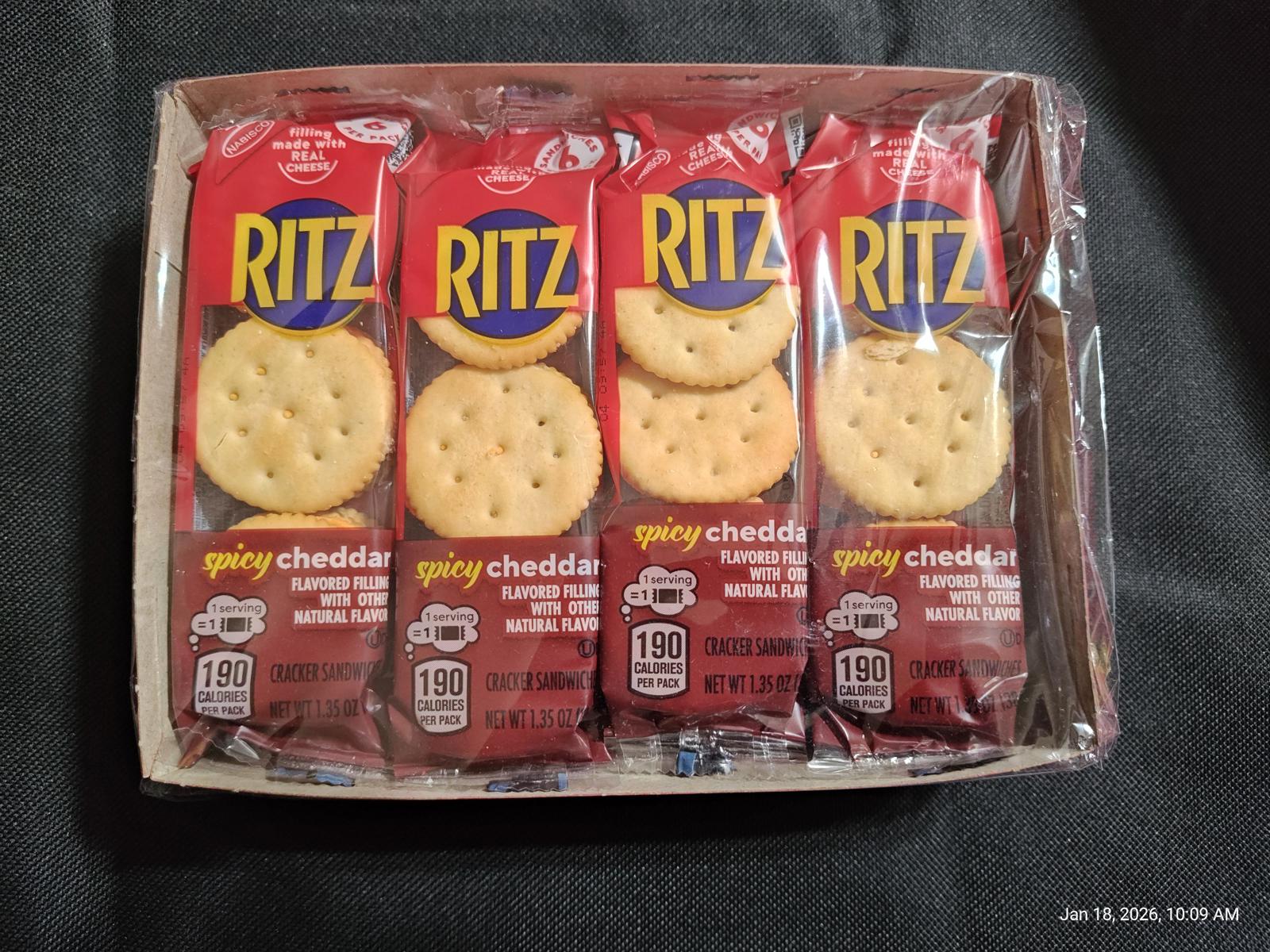 Ritz crackers with zesty cheddar flavor in a pack of four. Perfect for snacking.
