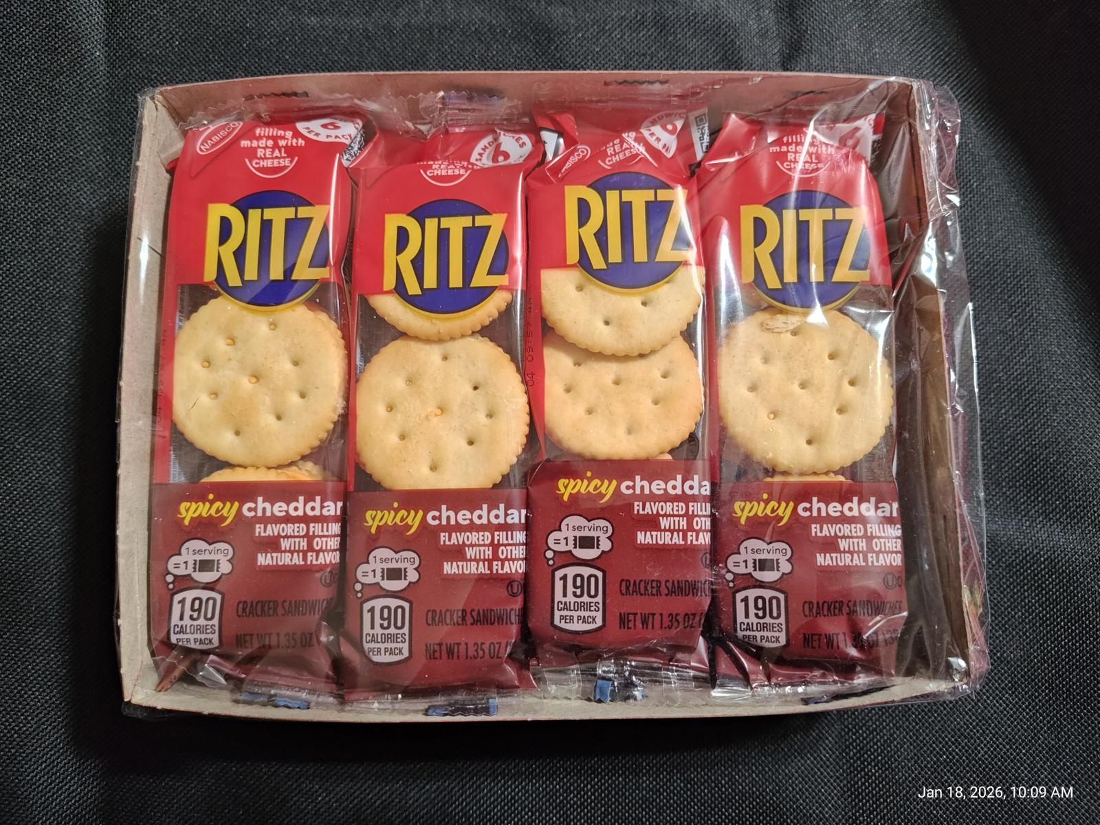 Ritz spicy cheddar crackers in a pack with four sleeves visible.