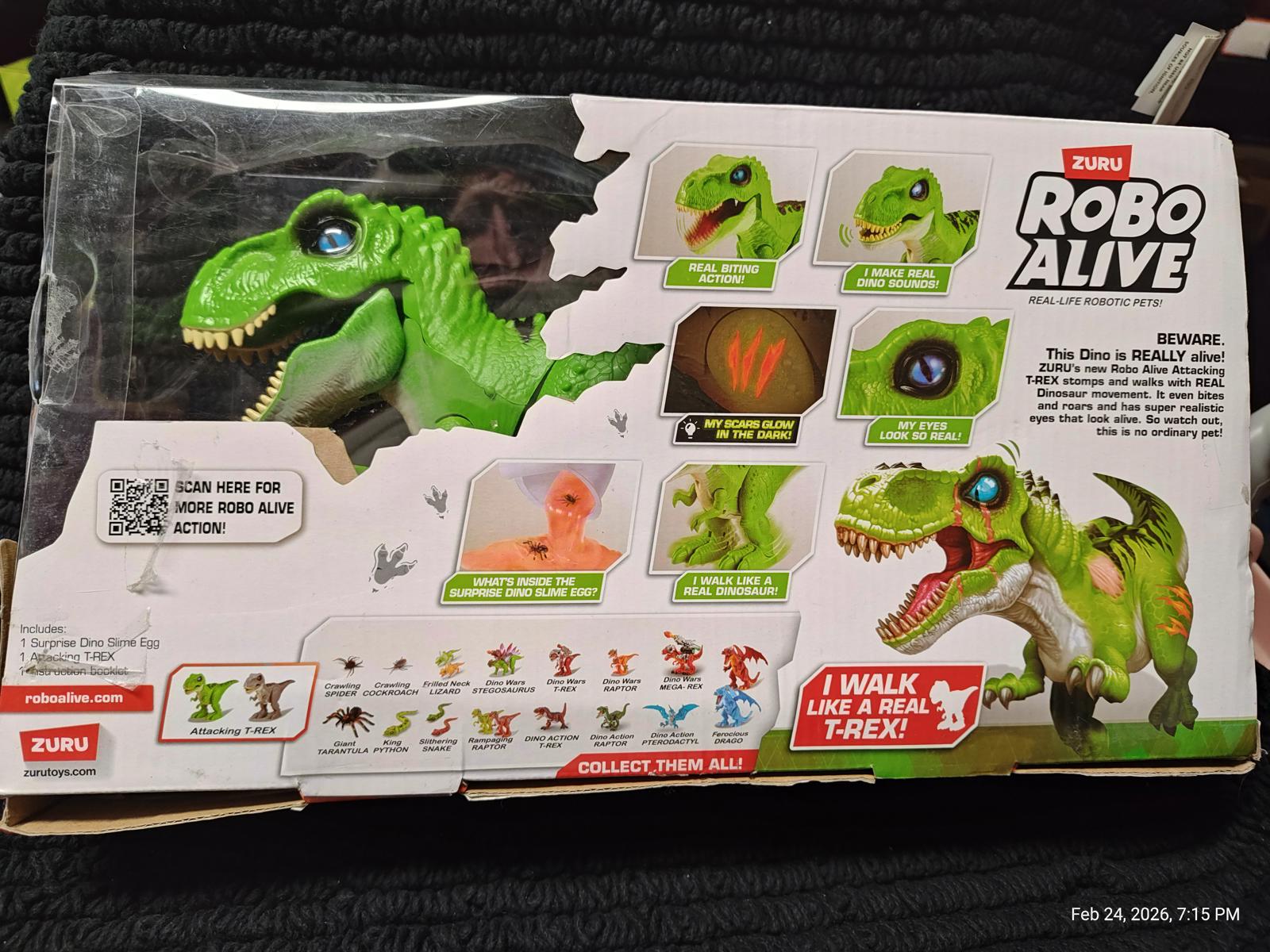 Robo Alive T-Rex toy packaging featuring a green dinosaur with interactive features.