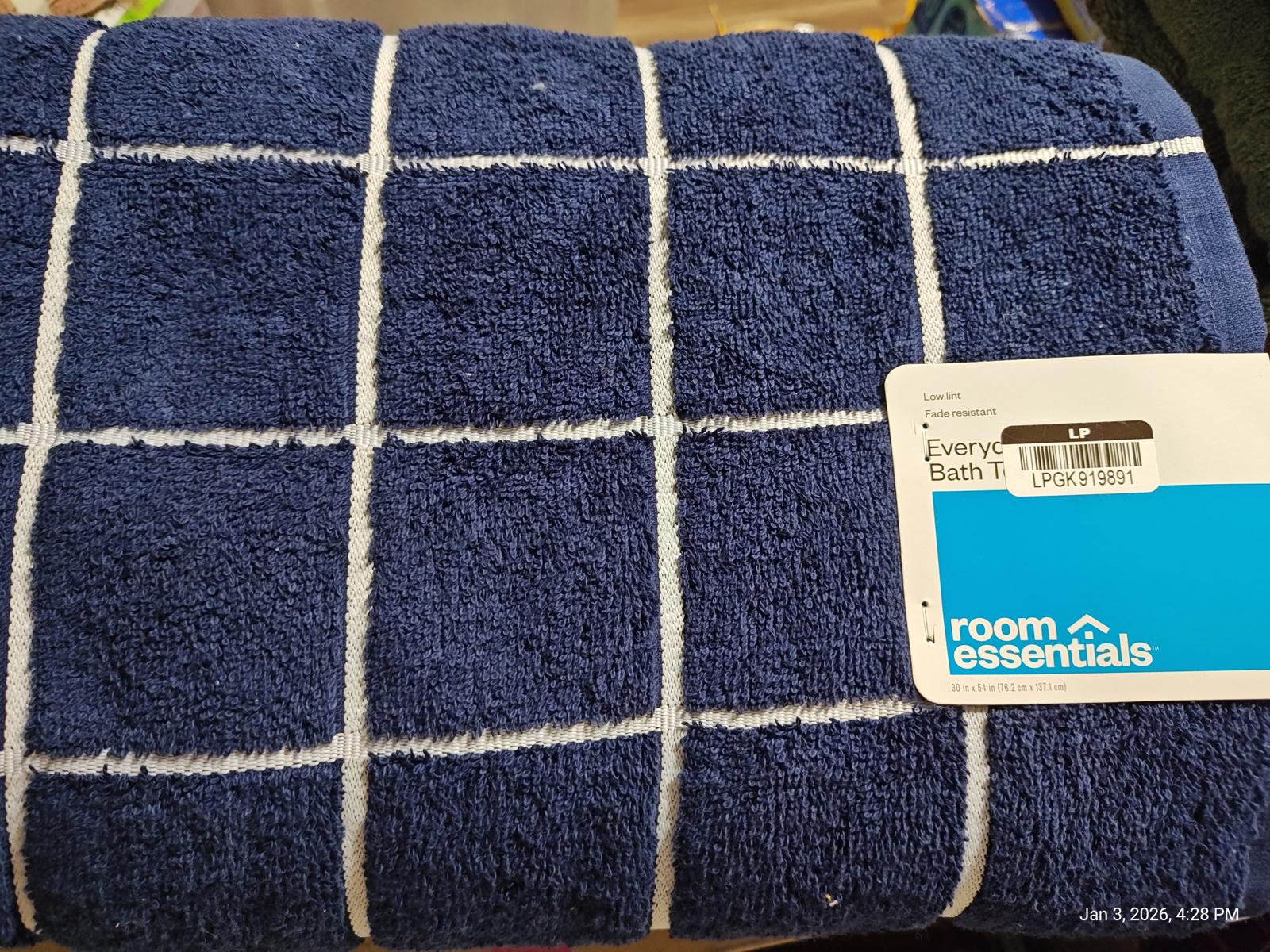 Room Essentials navy blue towel with white grid pattern.