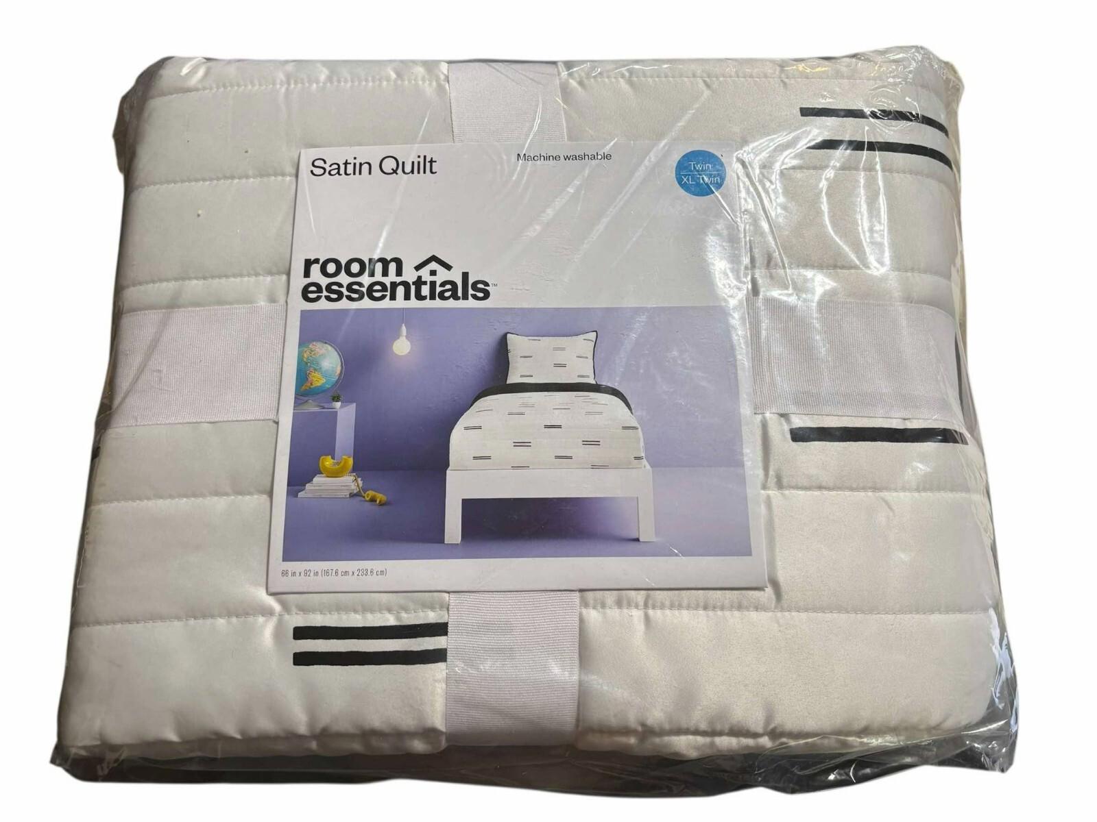 Room Essentials satin quilt featuring a white design with black stripes, perfect for bedding.