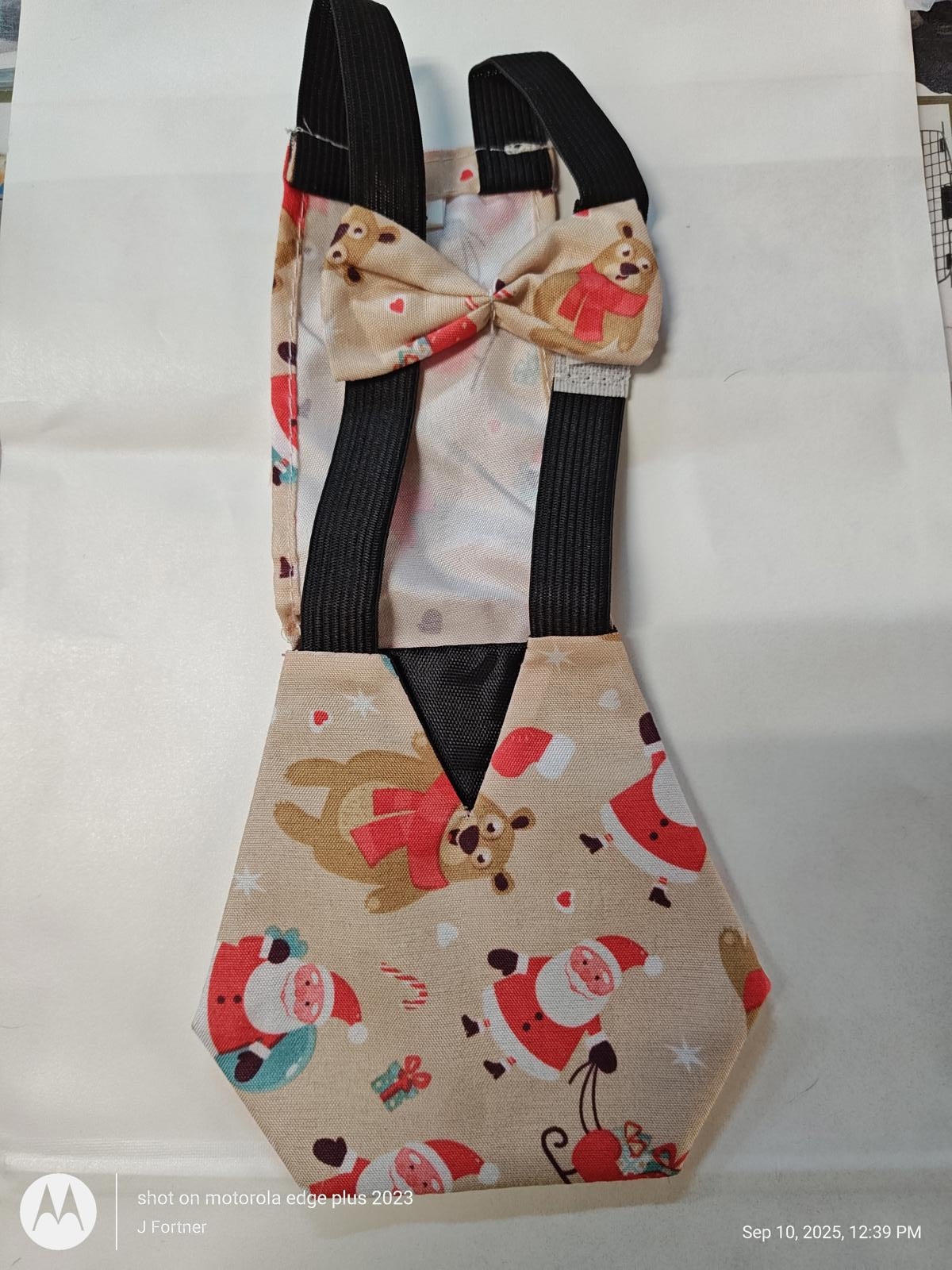 Santa Claus themed baby carrier with festive patterns and adjustable straps.