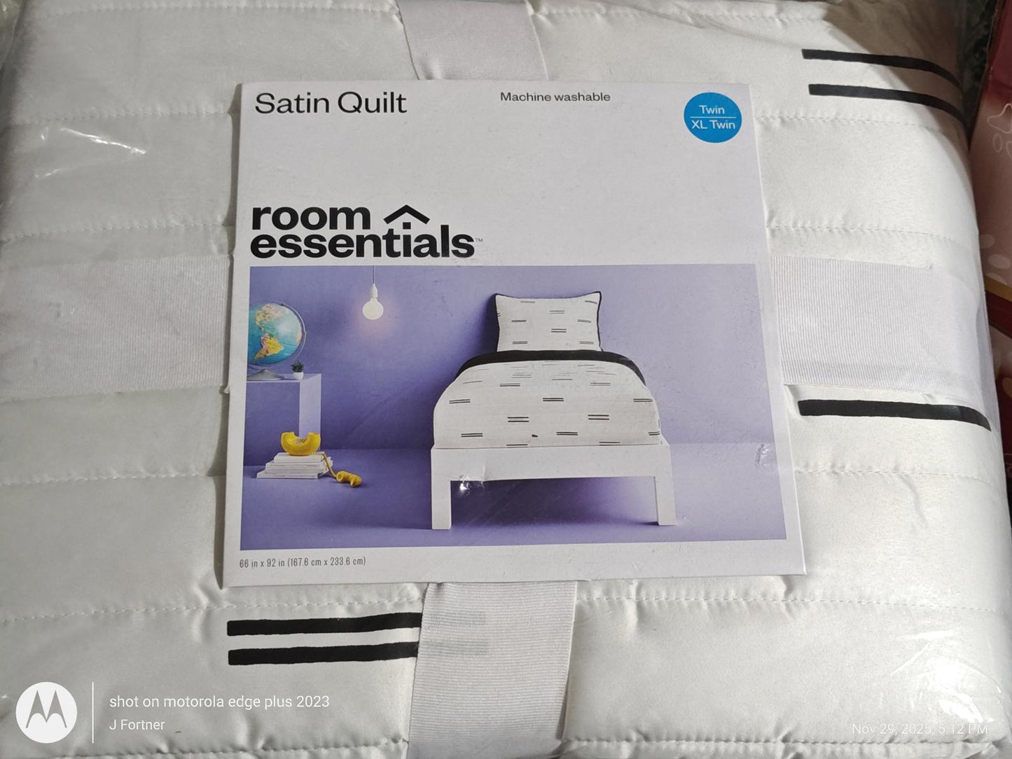 Satin Quilt by Room Essentials featuring a white design with black stripes and a modern bed setup.