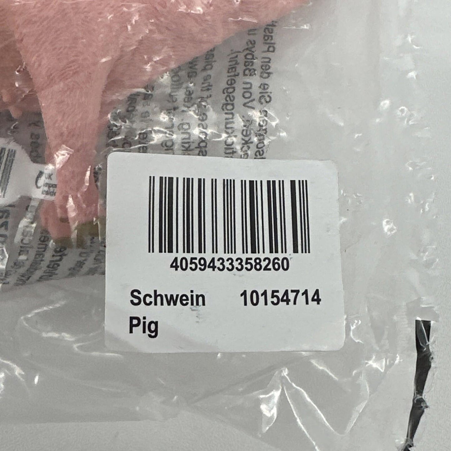 Schwein Pig plush toy in packaging with barcode visible.