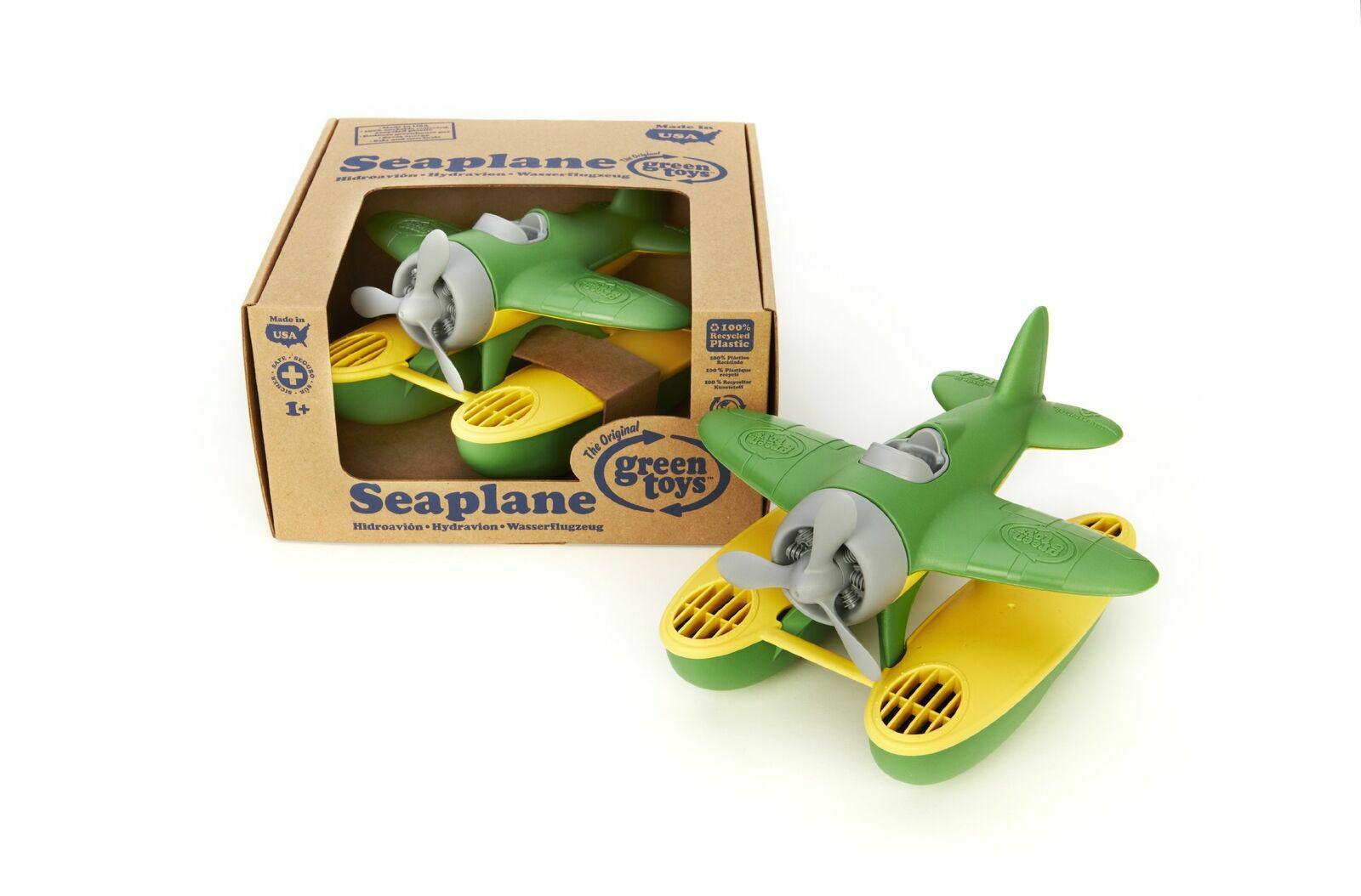 Seaplane toy in green and yellow with propeller, packaged in a box.