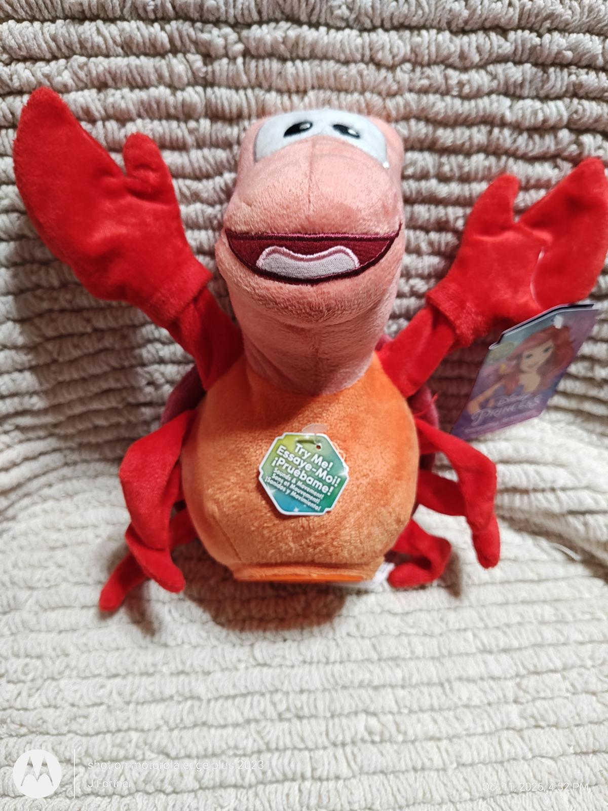 Sebastian plush toy featuring bright red claws and a cheerful expression.