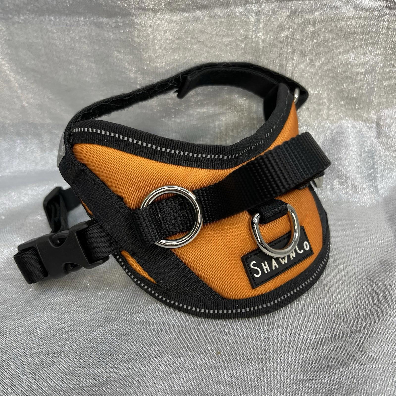 Shanico dog harness in orange and black with adjustable straps and metal D-ring.