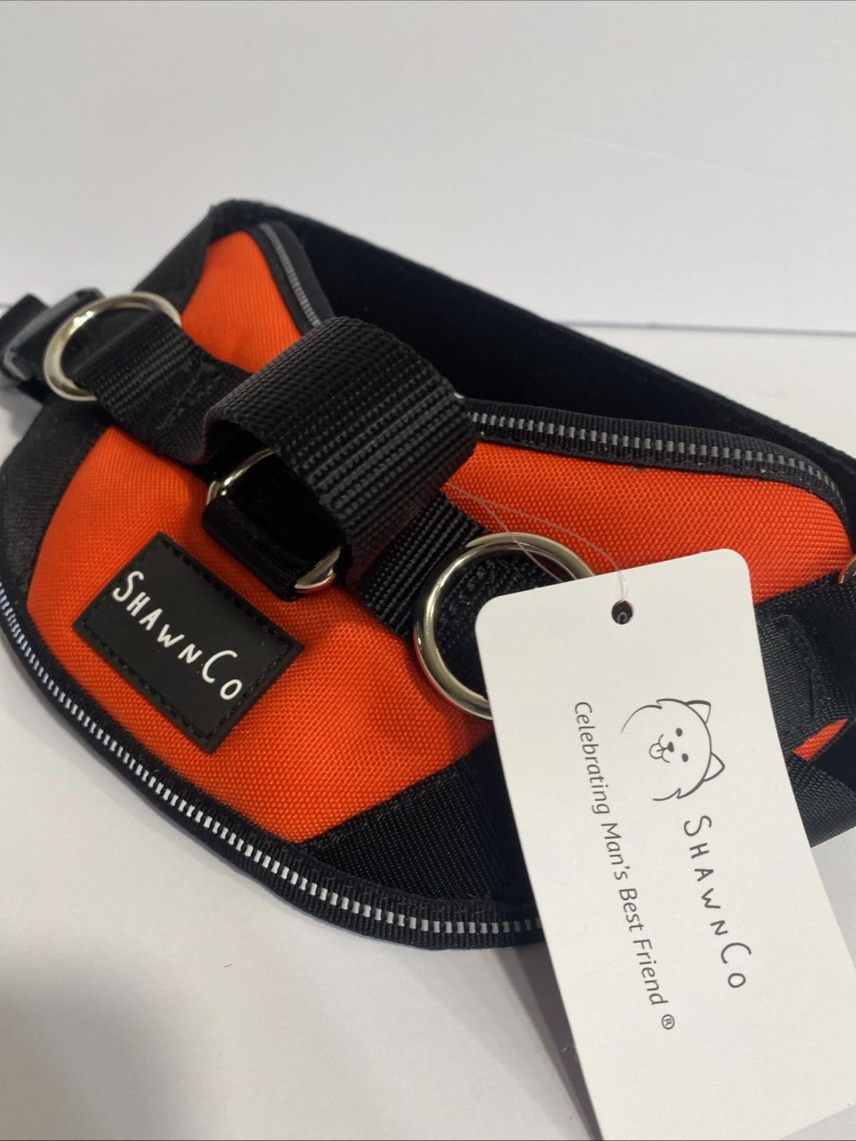 ShawnCo orange and black pet accessory with adjustable straps and logo tag.