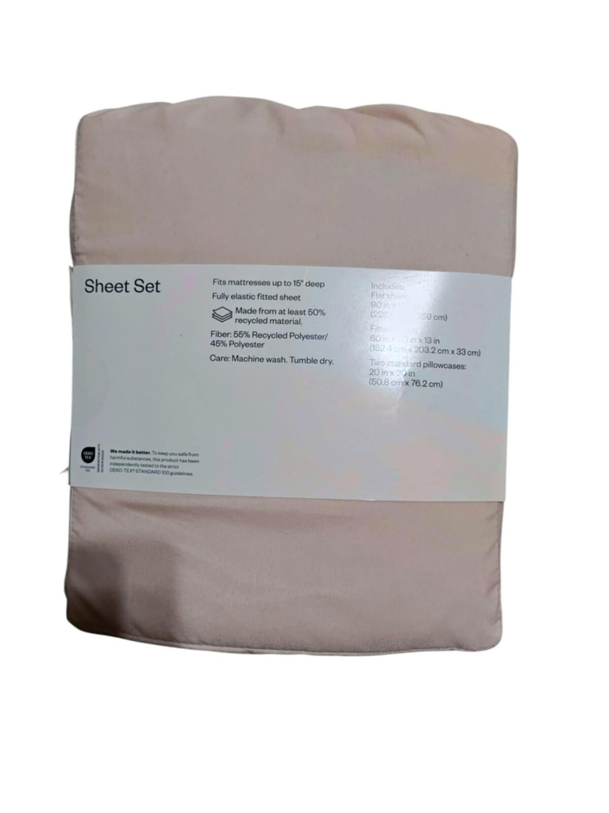 Sheet Set in soft pink color, featuring a label with care instructions and fabric details.