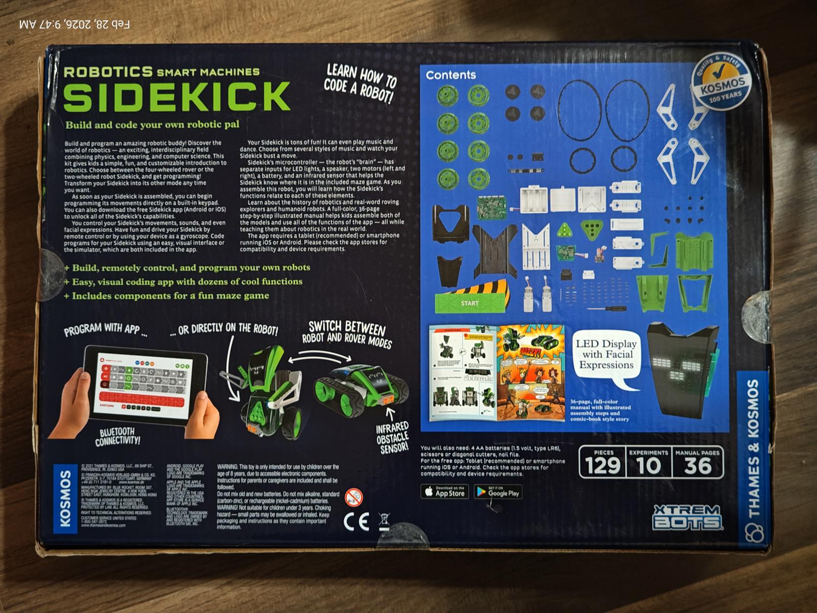Sidekick robot building kit with various components and instructions for assembly.