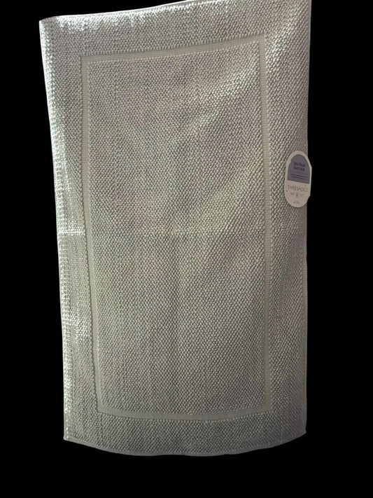 Textured silver kitchen towel with a decorative border and tag.