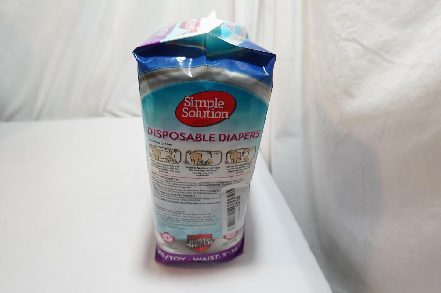Simple Solution disposable diapers package featuring clear instructions and colorful design.