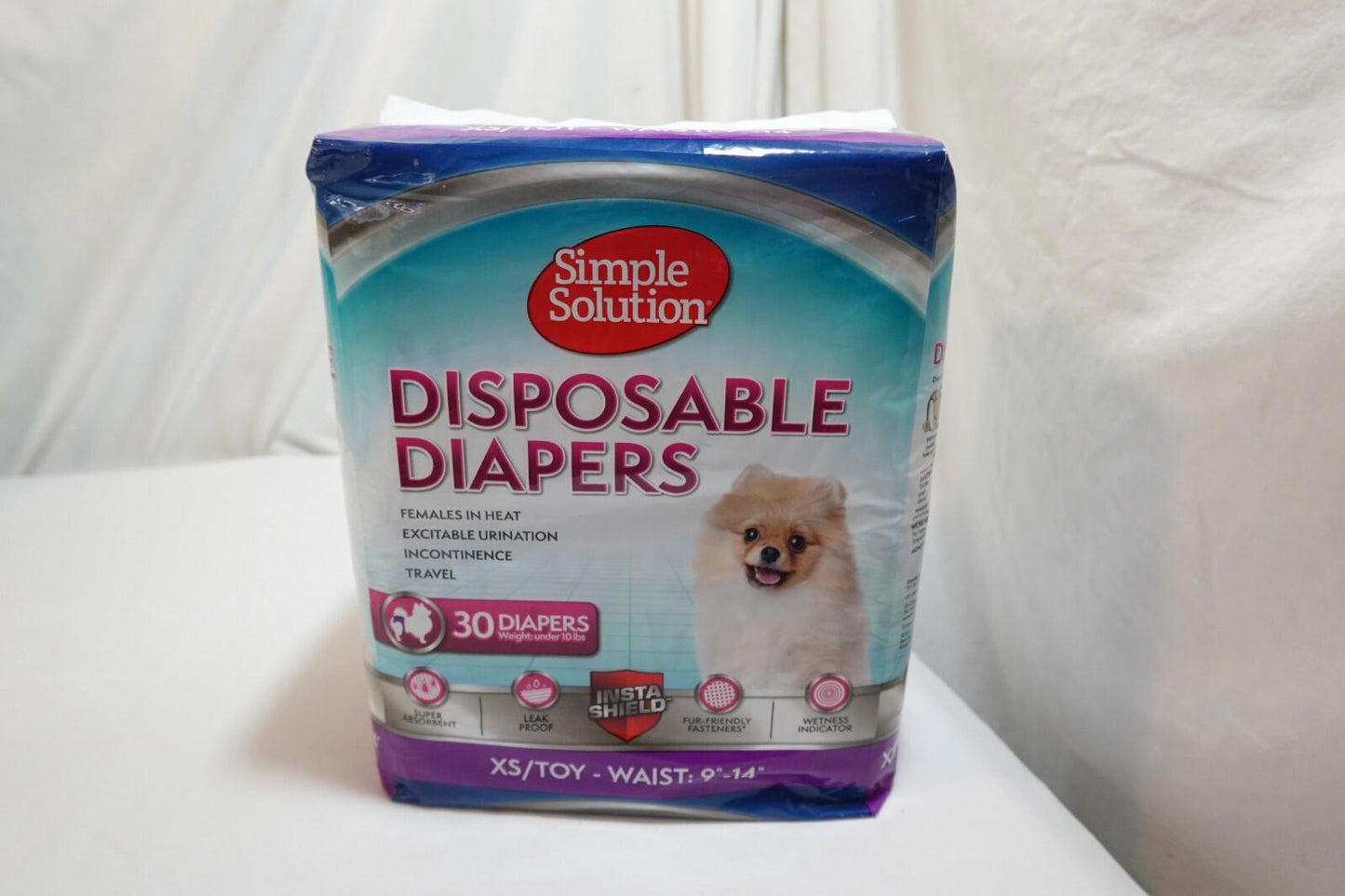 Simple Solution disposable diapers package featuring a cute dog on the front.