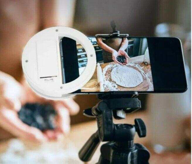 Smartphone camera lens attachment for enhanced photography, showing hands preparing dough.