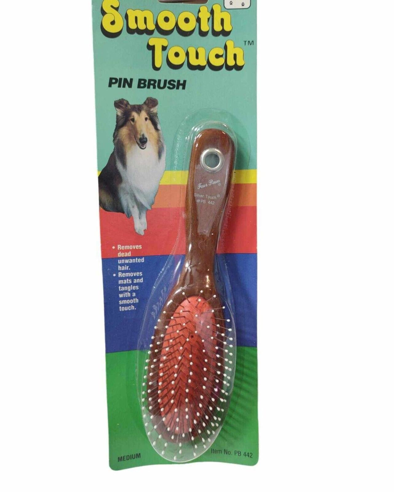 Smooth Touch pin brush with a wooden handle and red bristles for grooming pets.