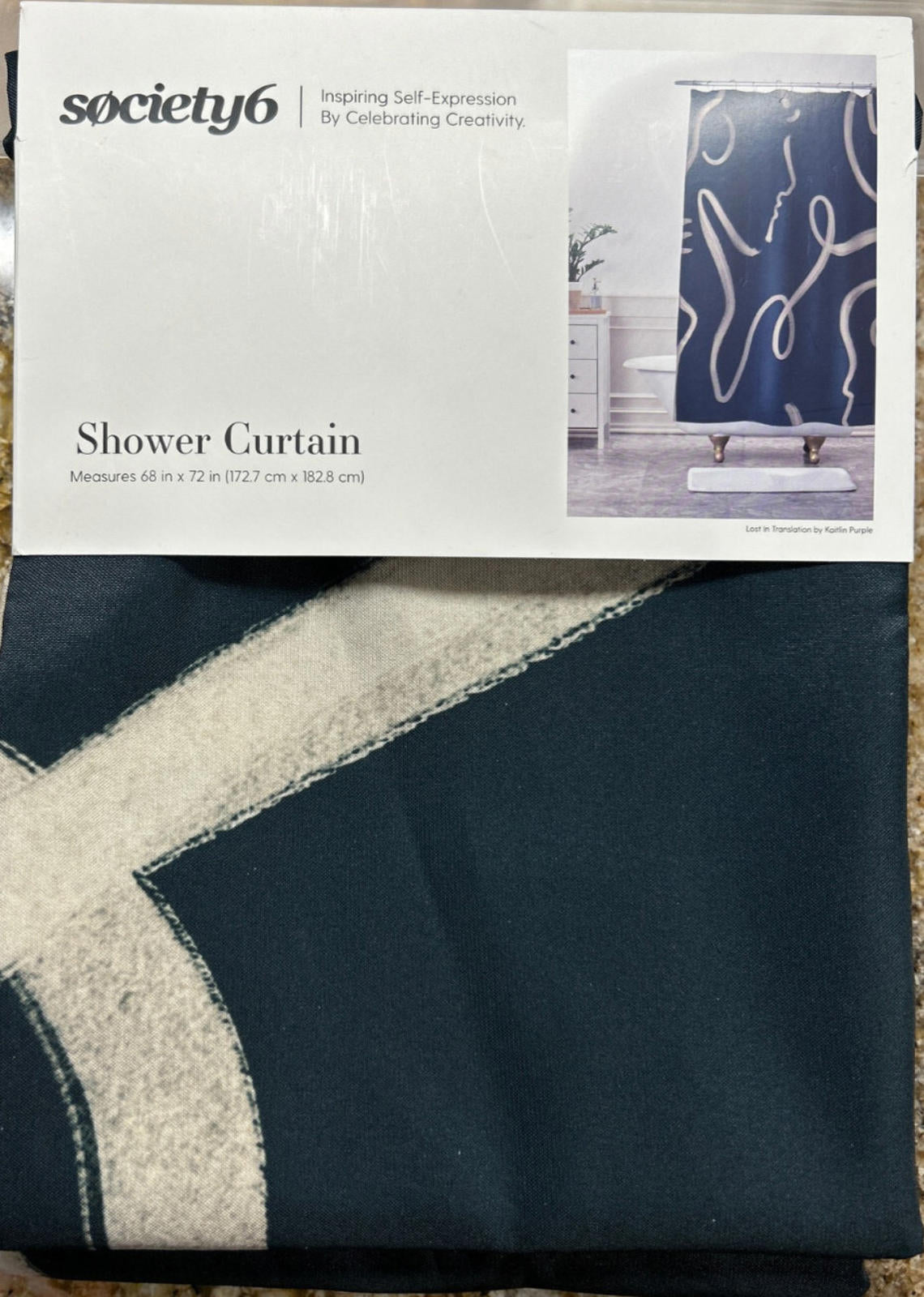 Society6 shower curtain featuring abstract design in dark blue and cream colors.