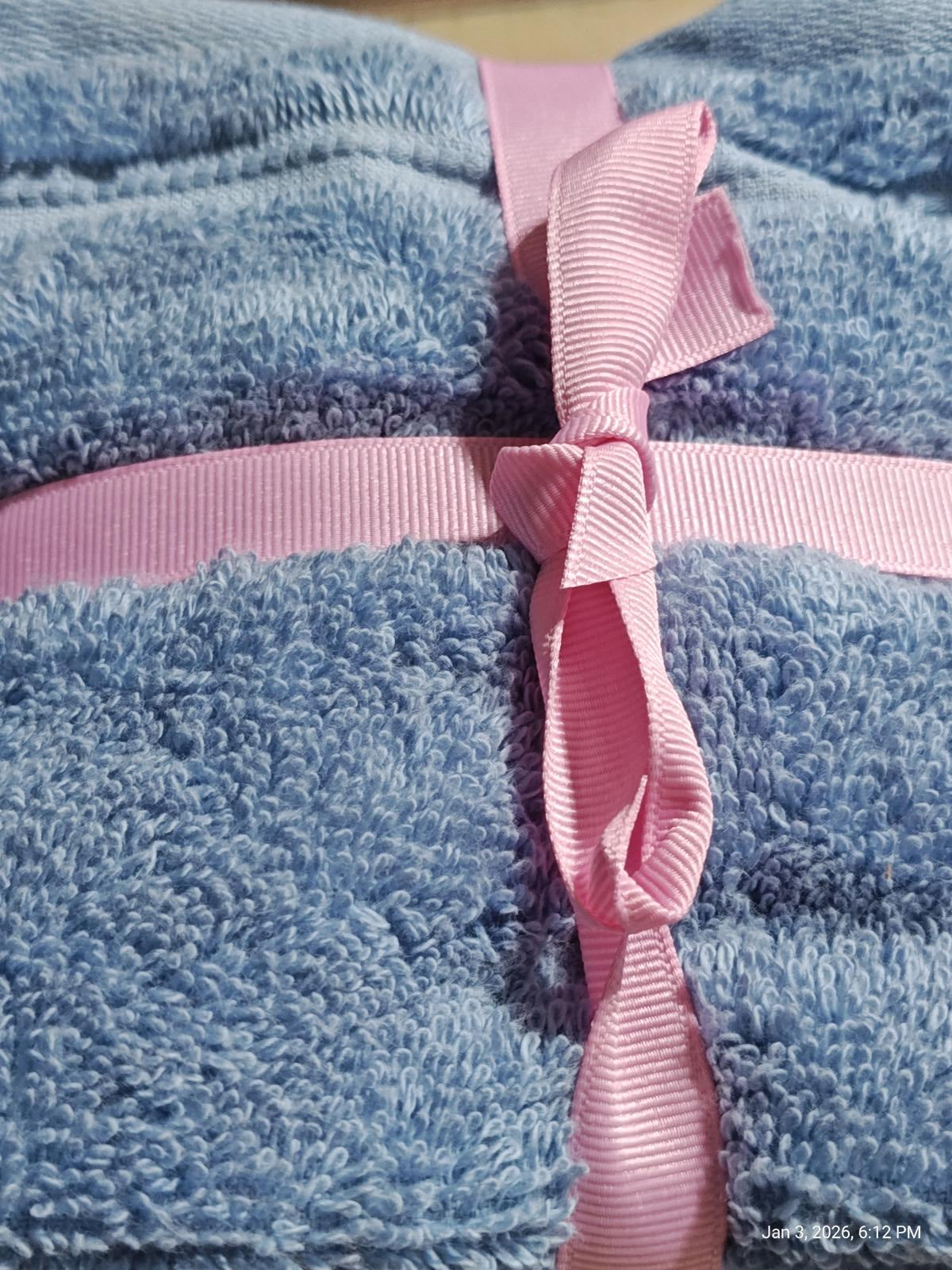Soft Blue Bath Towels set tied with a pink ribbon, showcasing plush texture and vibrant colors.