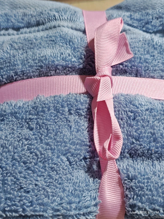 Soft Blue Bath Towels set tied with a pink ribbon, showcasing plush texture and vibrant colors.