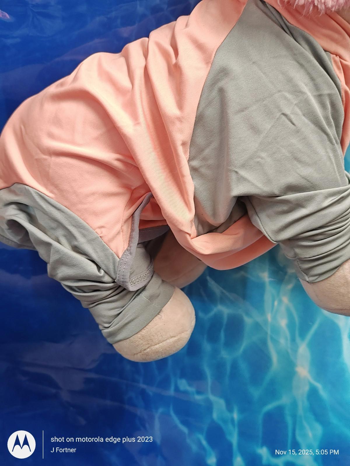 Product name not provided. Soft pink and gray fabric outfit with loose fit and plush texture.