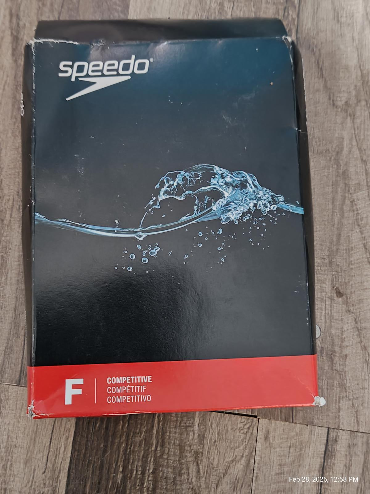 Speedo competitive swim cap featuring a sleek design with water splash graphics.