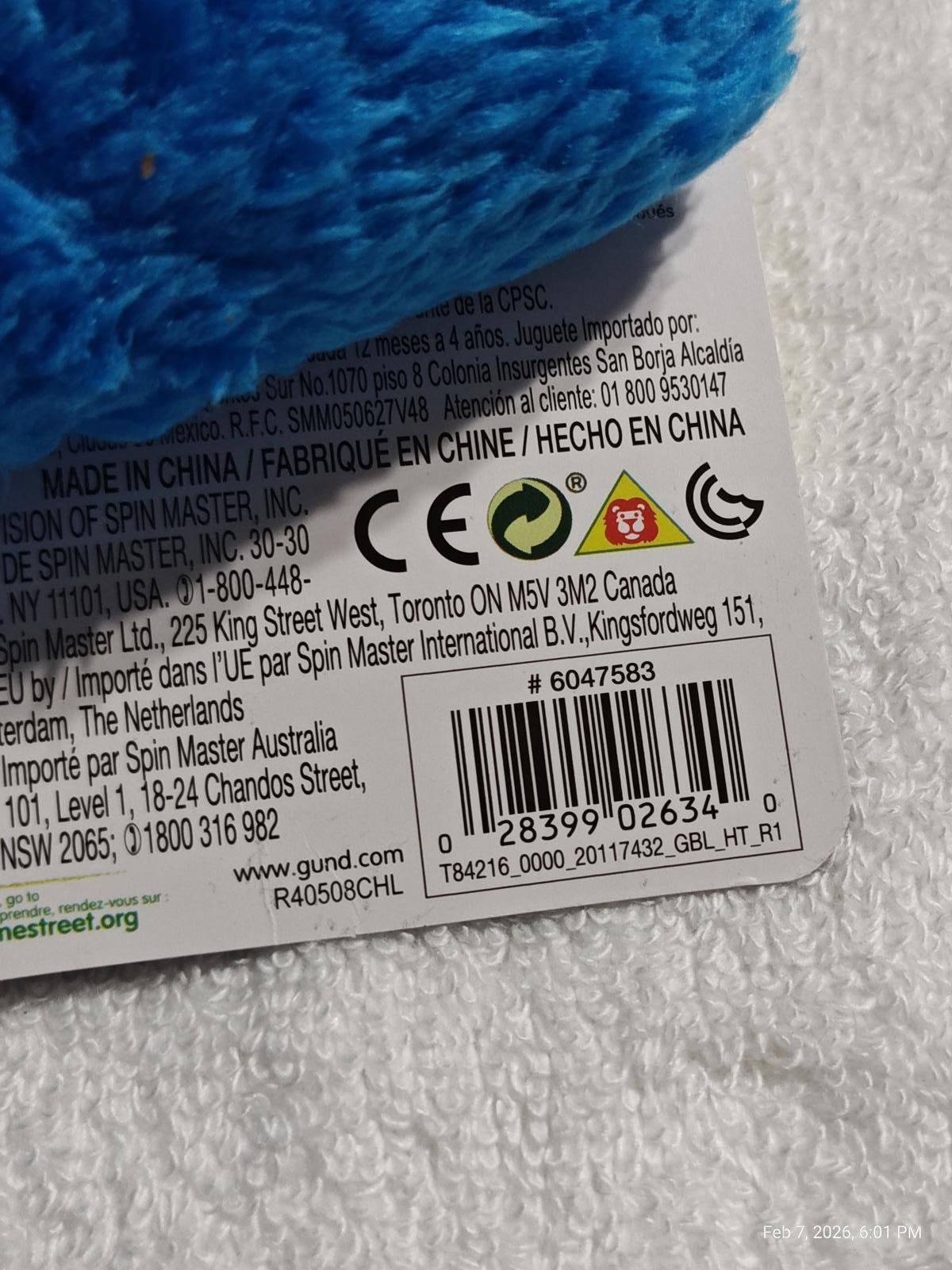 Spin Master plush toy tag with blue fur and care instructions.