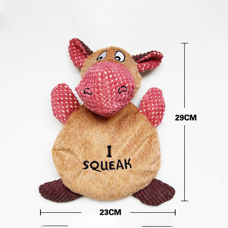 Squeaky plush toy cow with a smiling face and pink ears, measuring 29cm by 23cm.
