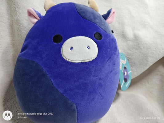 Squishmallow Blue Cow Plush Toy with soft texture and cute facial features.