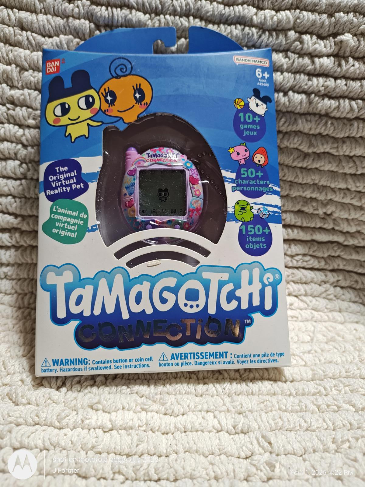 Tamagotchi Connection toy in colorful packaging with characters and features listed.