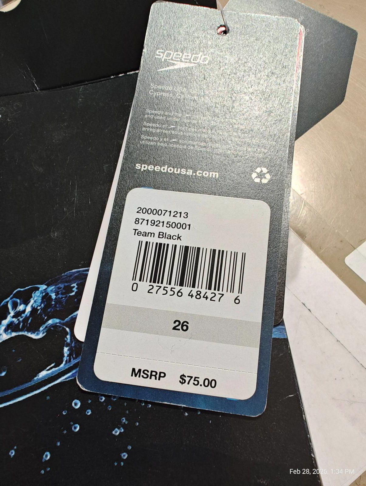 Team Black Speedo swimwear tag showing price and barcode details.