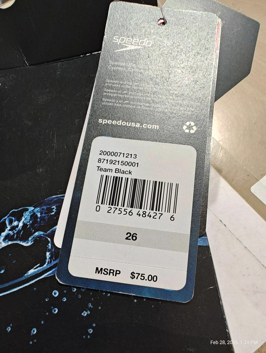 Team Black Speedo swimwear tag showing price and barcode details.