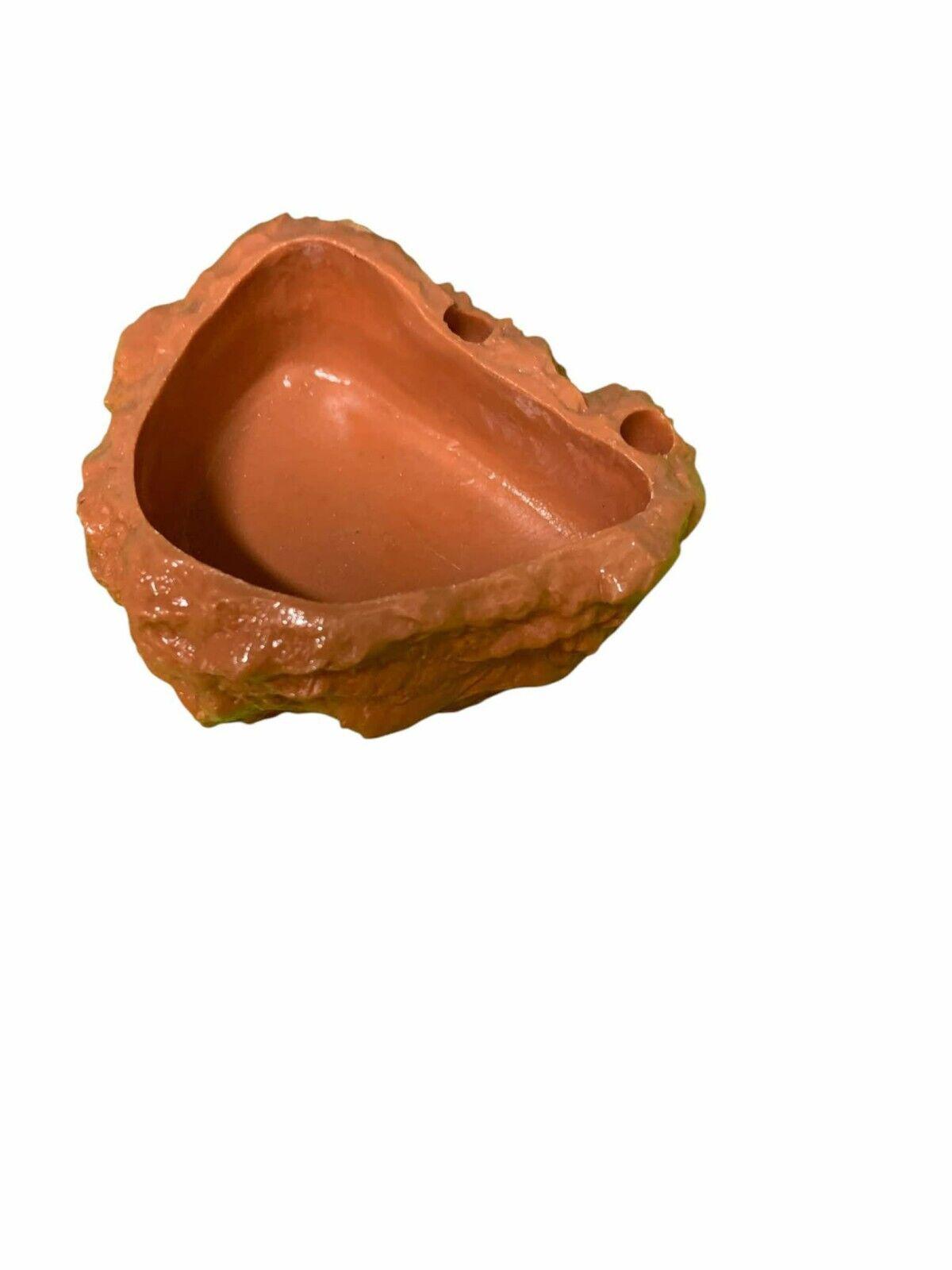 Terracotta rock-shaped bowl with a natural finish, ideal for decorative use.