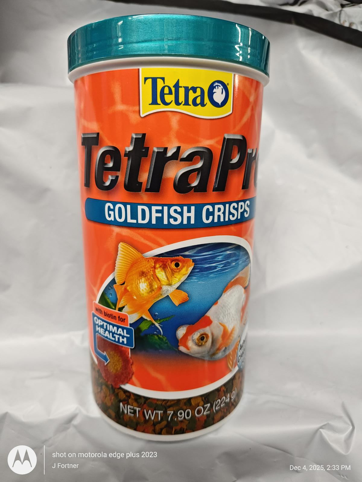 TetraPro Goldfish Crisps in a vibrant orange container, promoting optimal health for goldfish.